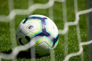 A close up of a football in a goal net
